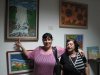 Hanah and daughter in front of Hanah's Oil paintings