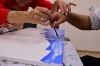 Art teacher Gina Meir-Duellmann helping Yihiel Edri paint his picture