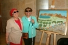 Zmira Alperin with Ester Yossef in front of Zmiras Painting "Glance at the Golan in Peace", 2015