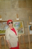 Ester Yossef in front of her picture "House in the Village"