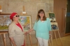 Ester Yossef with Anat ben Porat, secretary of the "Center for The Blinds in Israel", Tel-Aviv in front of her picture 