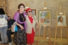 Ester Yossef with her Art teacher Gina Meir in front of her picture "House in the Village", Acrilic and molding paste, 2017