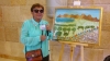 Zmira Alperin in front of her Painting "Glance at the Golan in Peace", 