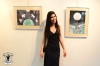 Tha artist Ronnie Oren in front of her pictures.
