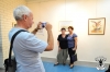 Artist Liber Gantman making a photo of his picture.