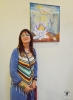 Artist Ana Miron in front of her picture