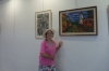 Artist Gina Meir in front of her pictures in this exhibition