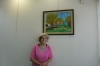 Artist Gina Meir in front of her picture in this exhibition