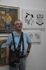 Artist Leonardo J. Grinberg near his artwork, portraits built by Hebrew letters.