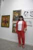 Artist Rosa Fenster in front of her paintings.