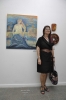 Artist Ana Miron in front of her painting.