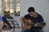 Natanel Yndman playing the guitar during the opening of the exhibition.