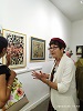 Artist Gina Meir Duellmann explaining her woodcuts to  the opening guests.