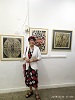 Artist Gina Meir Duellmann in front of her woodcuts.