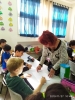 Fruits of Peace in Israel artist Aliza Borshaks explaining her workshop in "Painting motivated by Alizas Painting" for a class of elementary Jewish-Arabic school "Degania", Beersheba, November 2019
