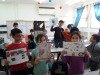 Children showing their ready paintings after Aliza Borshaks workshop in "Painting motivated by Alizas Paintings" for a class of elementary Jewish-Arabic school "Degania", Beersheba, November 2019, with colleague artist Ana Mirons assistance