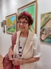 Gina Meir Duellmann taking part at the exhibition "Culture Colors" at the Ayelet Boker Gallery in Tel-Aviv, with Jewish and Arab Artists from all Israel, with her two paintings in the background, on the 11th. of July 2019.