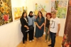 Artists in front of their artworks and Rosa Psanters, member of "Fruits of Peace in Israel" paintings participating at the exhibition.