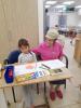 Danielle,  6 years old daughter of a Kibbutz couple with Gina, preparing a picture for the Jewish New Year, 3rd of October 2024.